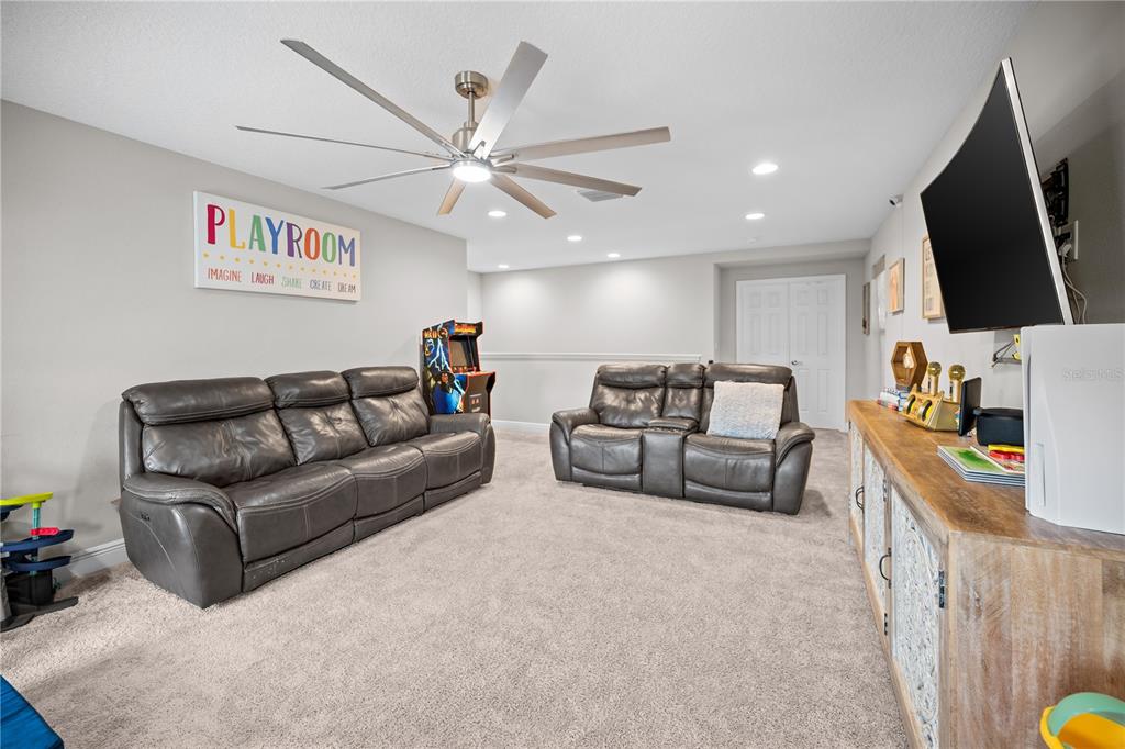 14734 Horse Trot Road Lithia, FL 33547 - Photo 43 of 66 a living room with furniture and a flat screen tv
