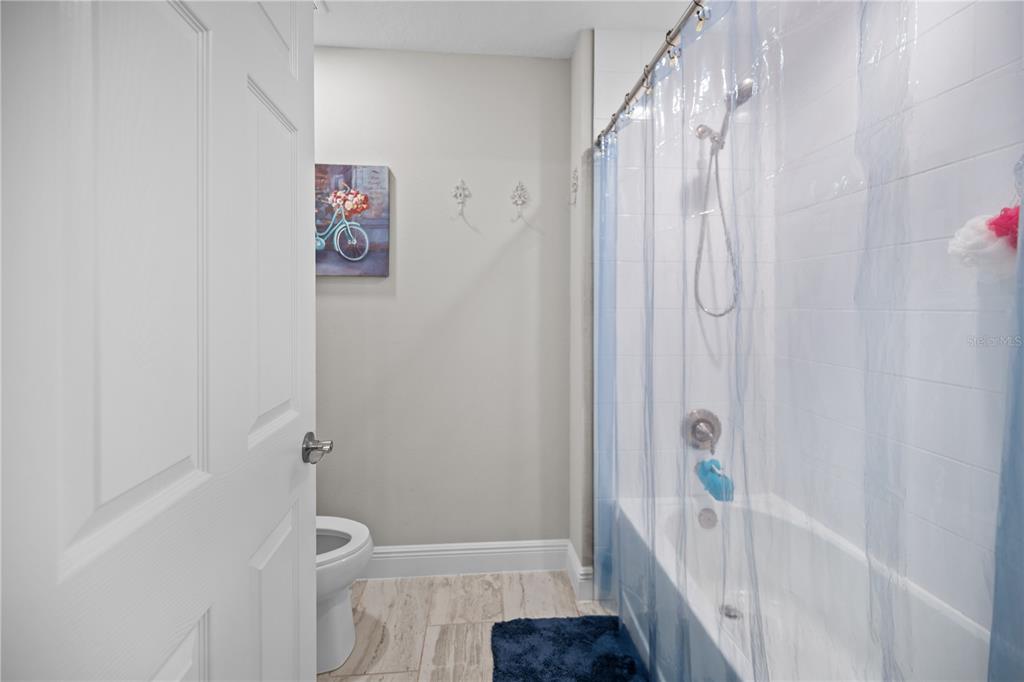 14734 Horse Trot Road Lithia, FL 33547 - Photo 50 of 66 a bathroom with a shower curtain and a sink