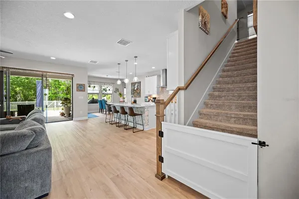 a view of a livingroom with furniture and staircase