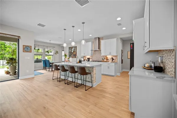 a kitchen with stainless steel appliances kitchen island granite countertop a sink and cabinets