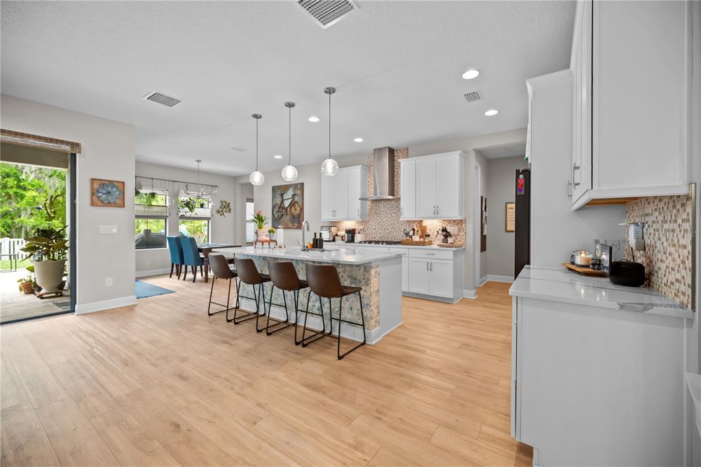 14734 Horse Trot Road Lithia, FL 33547 - Photo 6 of 66 a kitchen with stainless steel appliances kitchen island granite countertop a sink and cabinets
