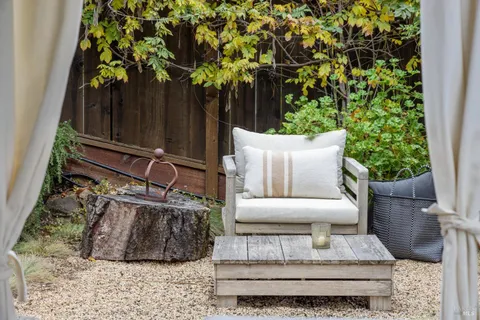a living room with furniture flower pot and a flat screen tv