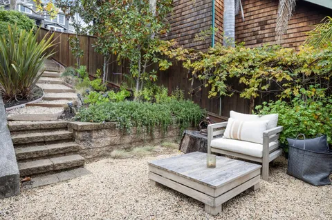a living room filled with furniture and a painting on the wall
