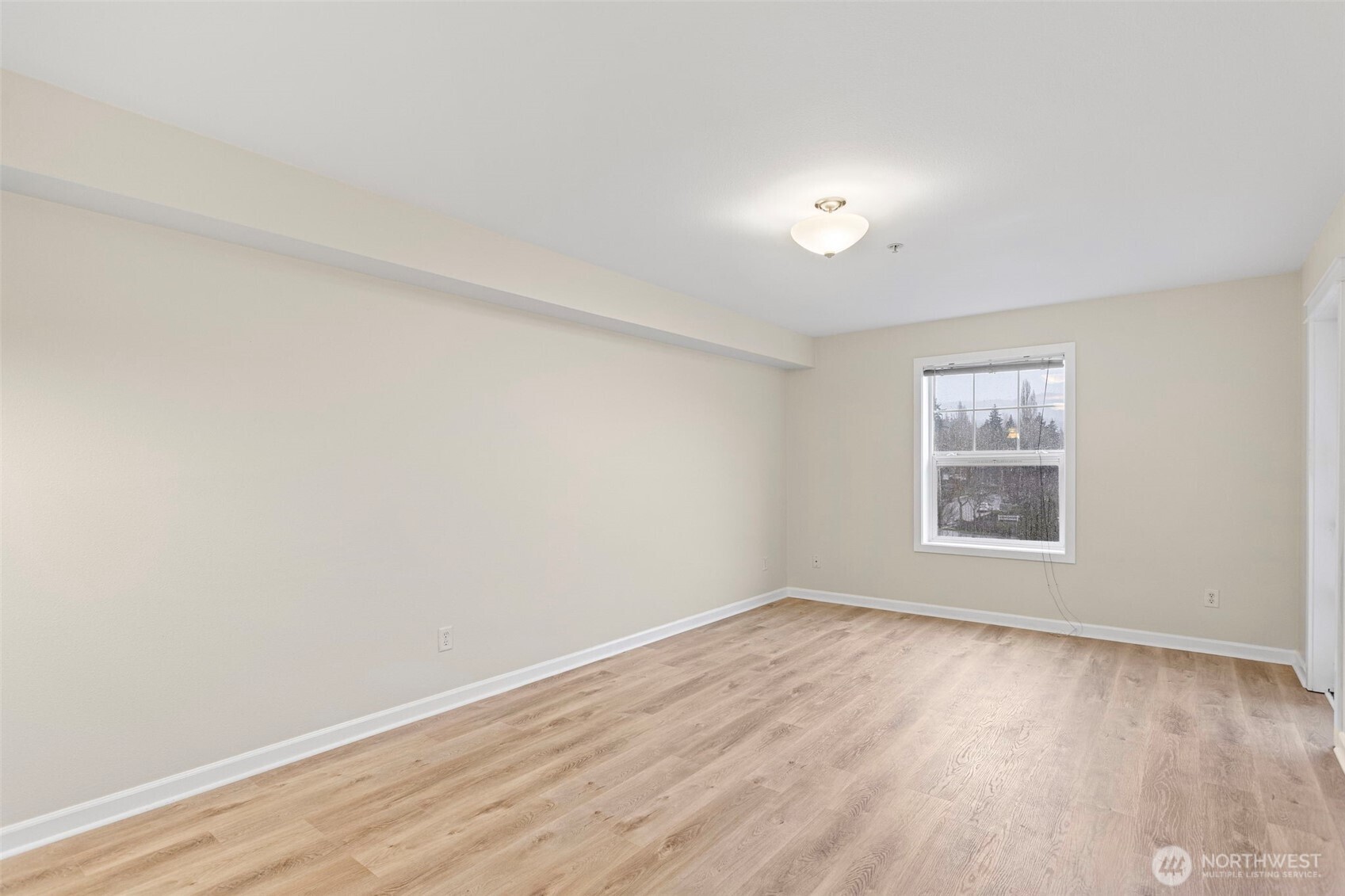 700 32nd Street, Unit A310 Bellingham, WA 98225 - Photo 6 of 12 an empty room with wooden floor and windows