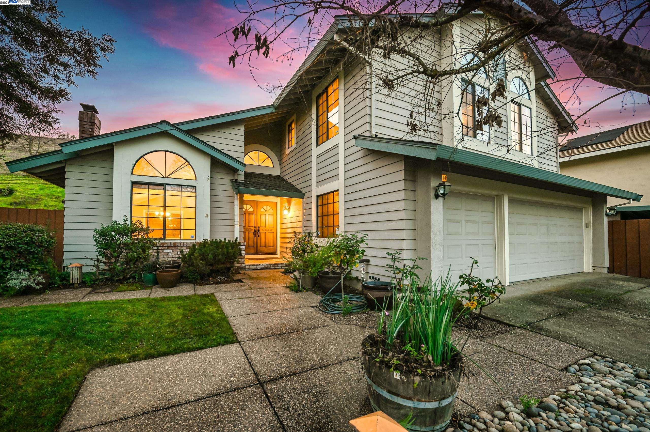 a front view of a house with garden