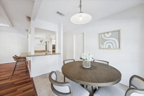 a dining room with table chairs and a chandelier