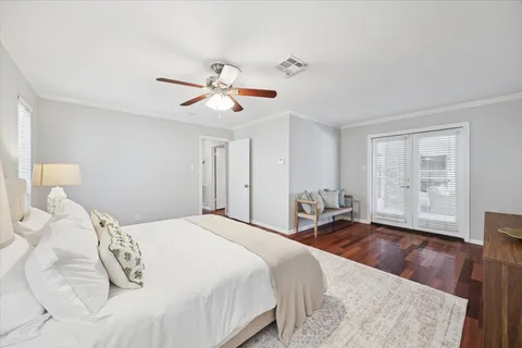 a bedroom with a large bed and a chandelier
