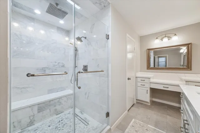 a bathroom with a shower a mirror and a sink