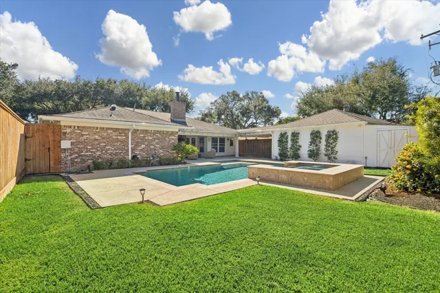 a view of house with swimming pool outdoor seating