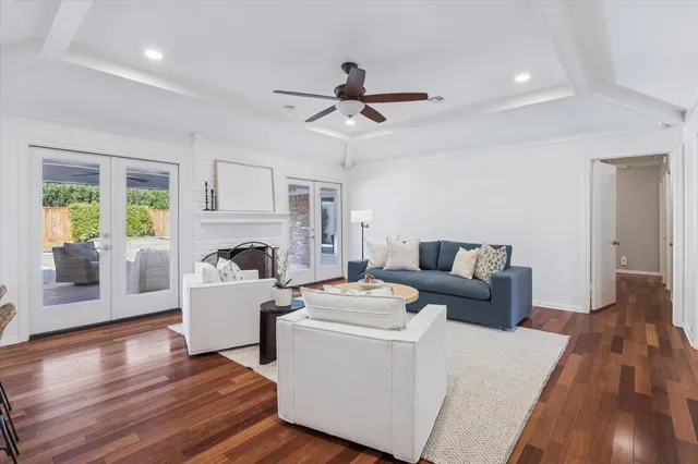 a living room with furniture fireplace and wooden floor