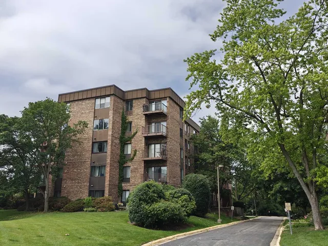 front view of a brick house with a yard