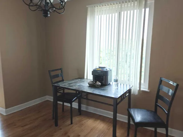 a view of a workspace with furniture and window