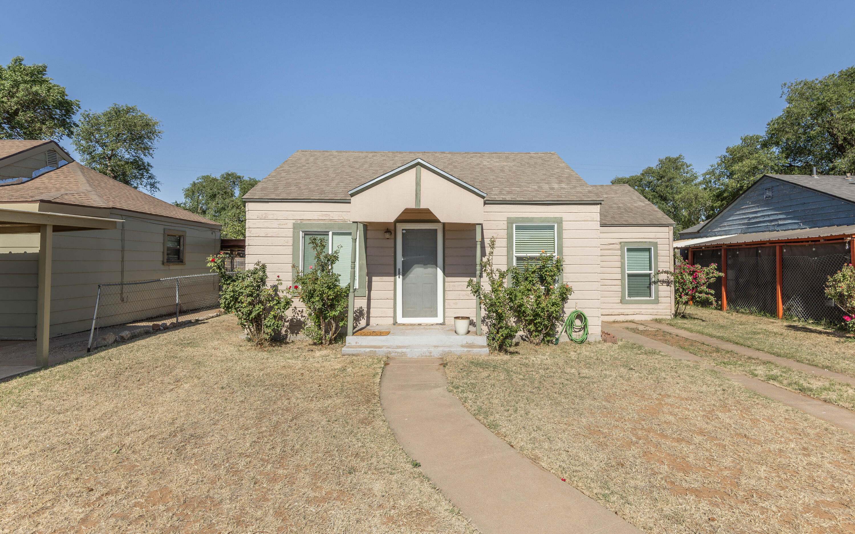 110 Uvalde Avenue Lubbock, TX 79415 - Photo 1 of 15 a front view of a house with a yard and potted plants