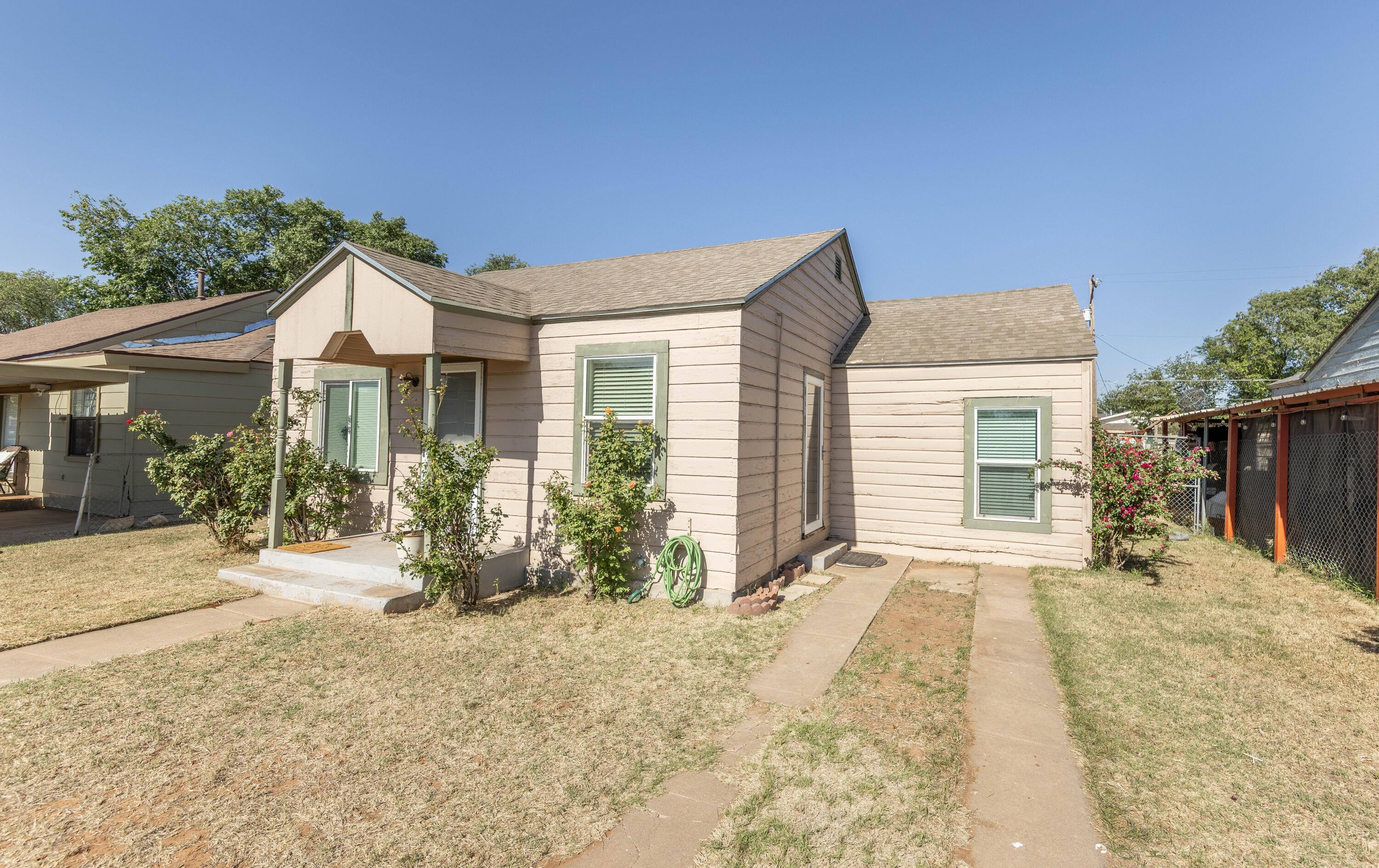 110 Uvalde Avenue Lubbock, TX 79415 - Photo 14 of 15 a front view of a house with a yard outdoor seating and barbeque oven