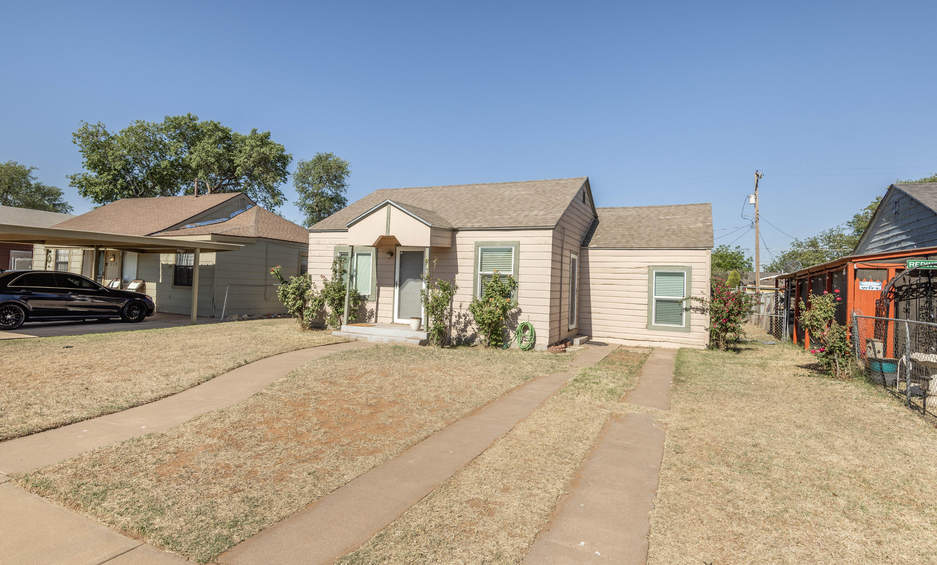 110 Uvalde Avenue Lubbock, TX 79415 - Photo 15 of 15 a front view of a house with a yard and garage