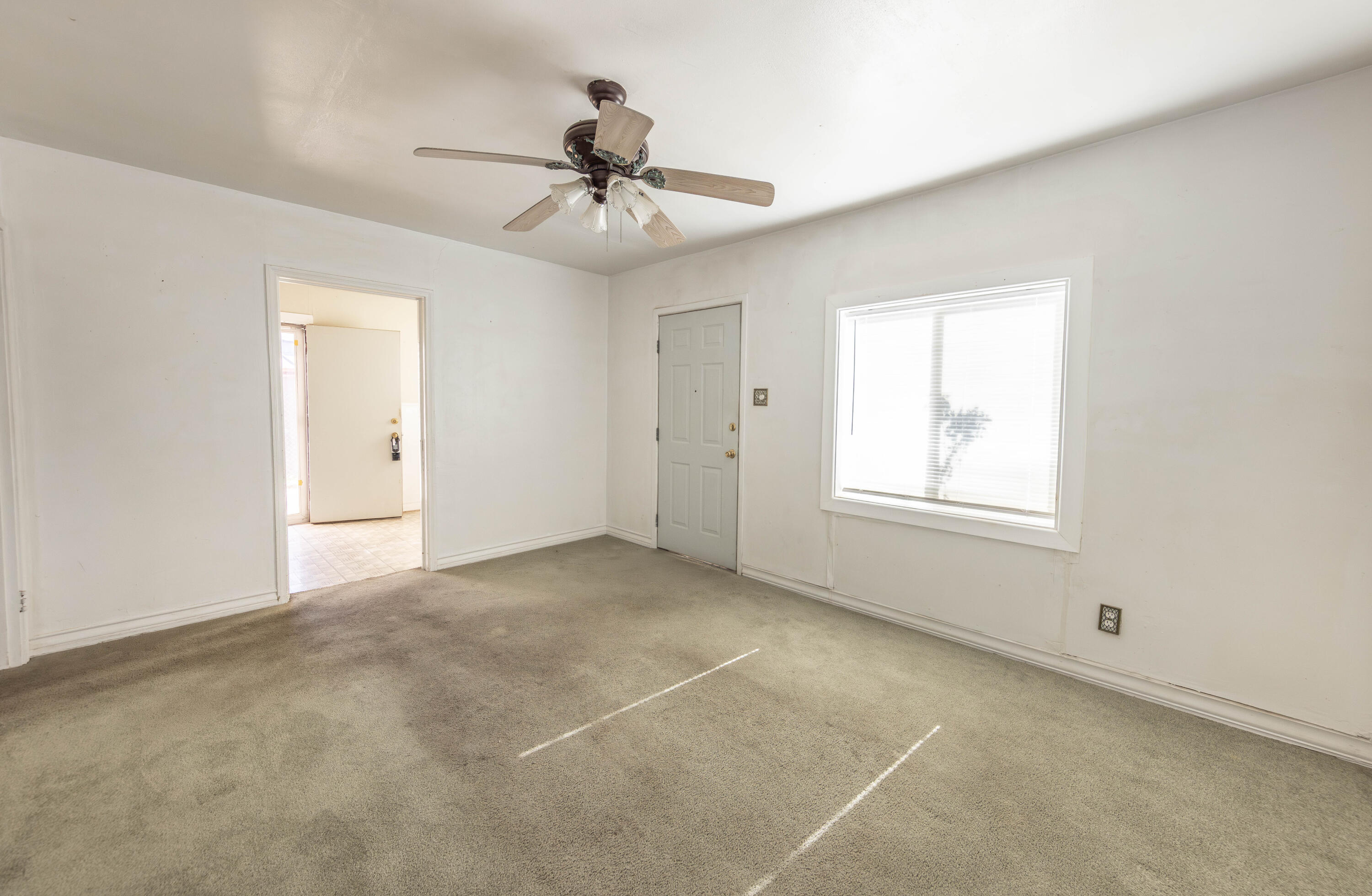 110 Uvalde Avenue Lubbock, TX 79415 - Photo 2 of 15 a view of an empty room with a window