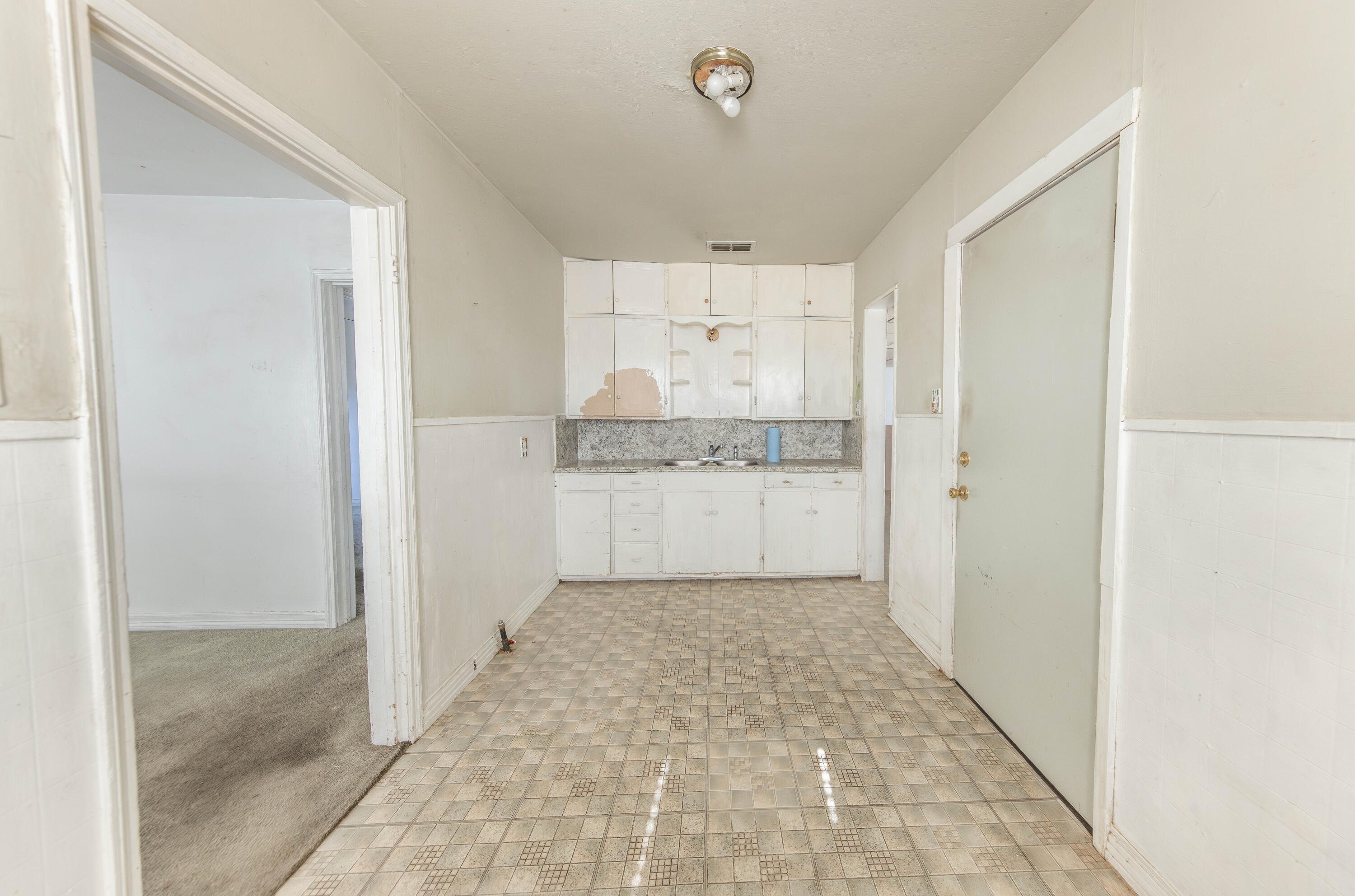 110 Uvalde Avenue Lubbock, TX 79415 - Photo 4 of 15 a view of a kitchen with white cabinets