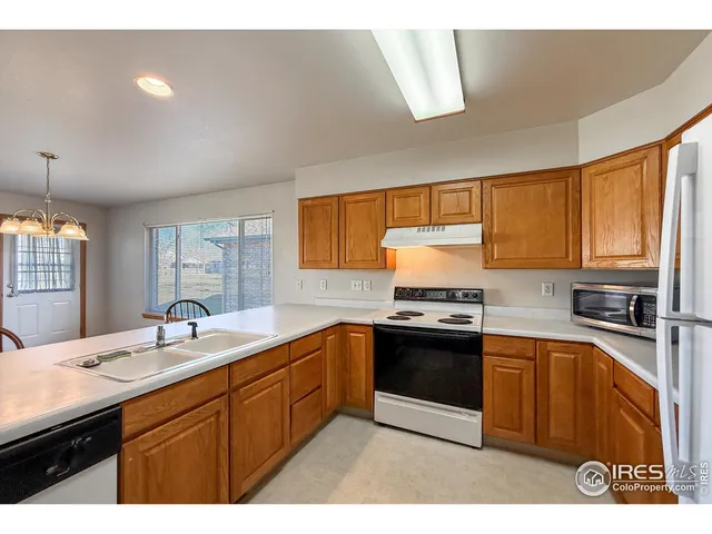 a kitchen with stainless steel appliances granite countertop a sink stove window and cabinets