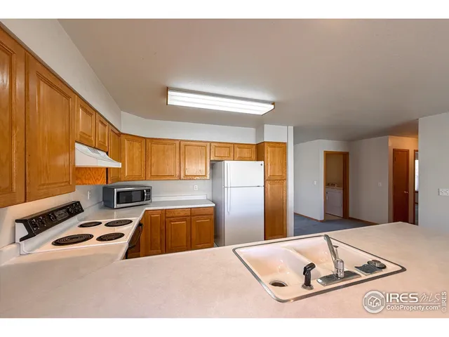 a kitchen with a refrigerator sink and a stove