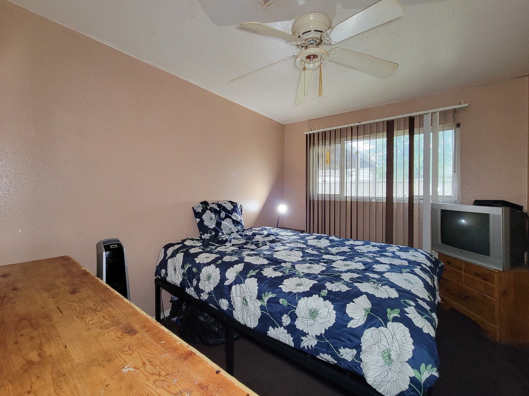 1330 Mosher Lane Houston, TX 77088 - Photo 11 of 16 a bedroom with a bed and a chandelier