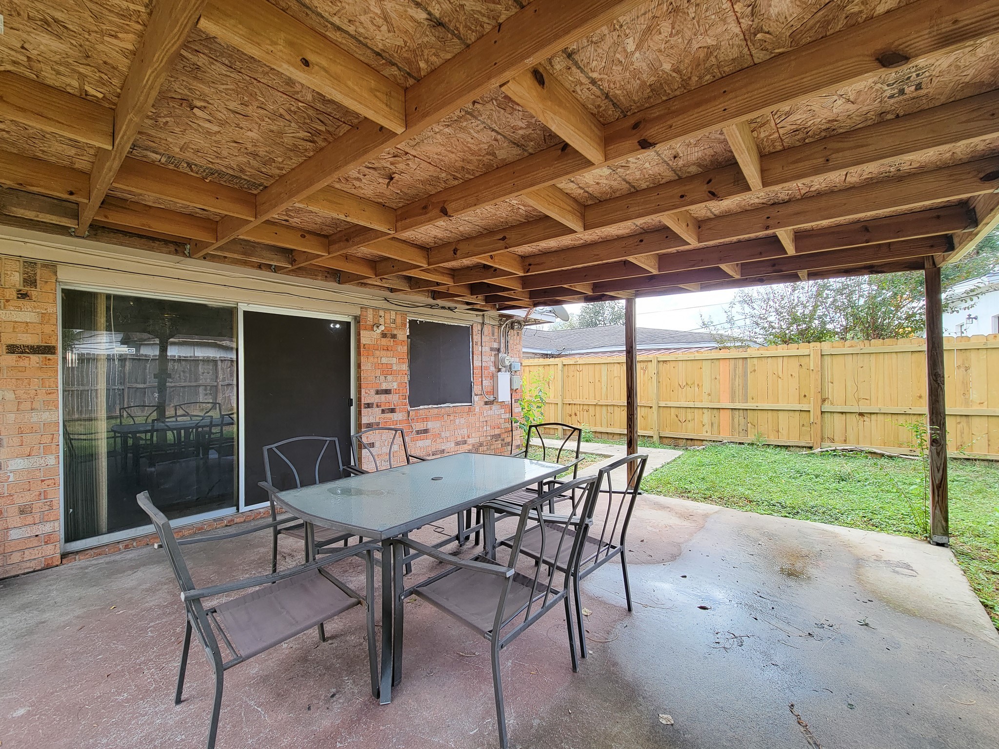 1330 Mosher Lane Houston, TX 77088 - Photo 14 of 16 a view of a patio with a table and chairs under a large umbrella