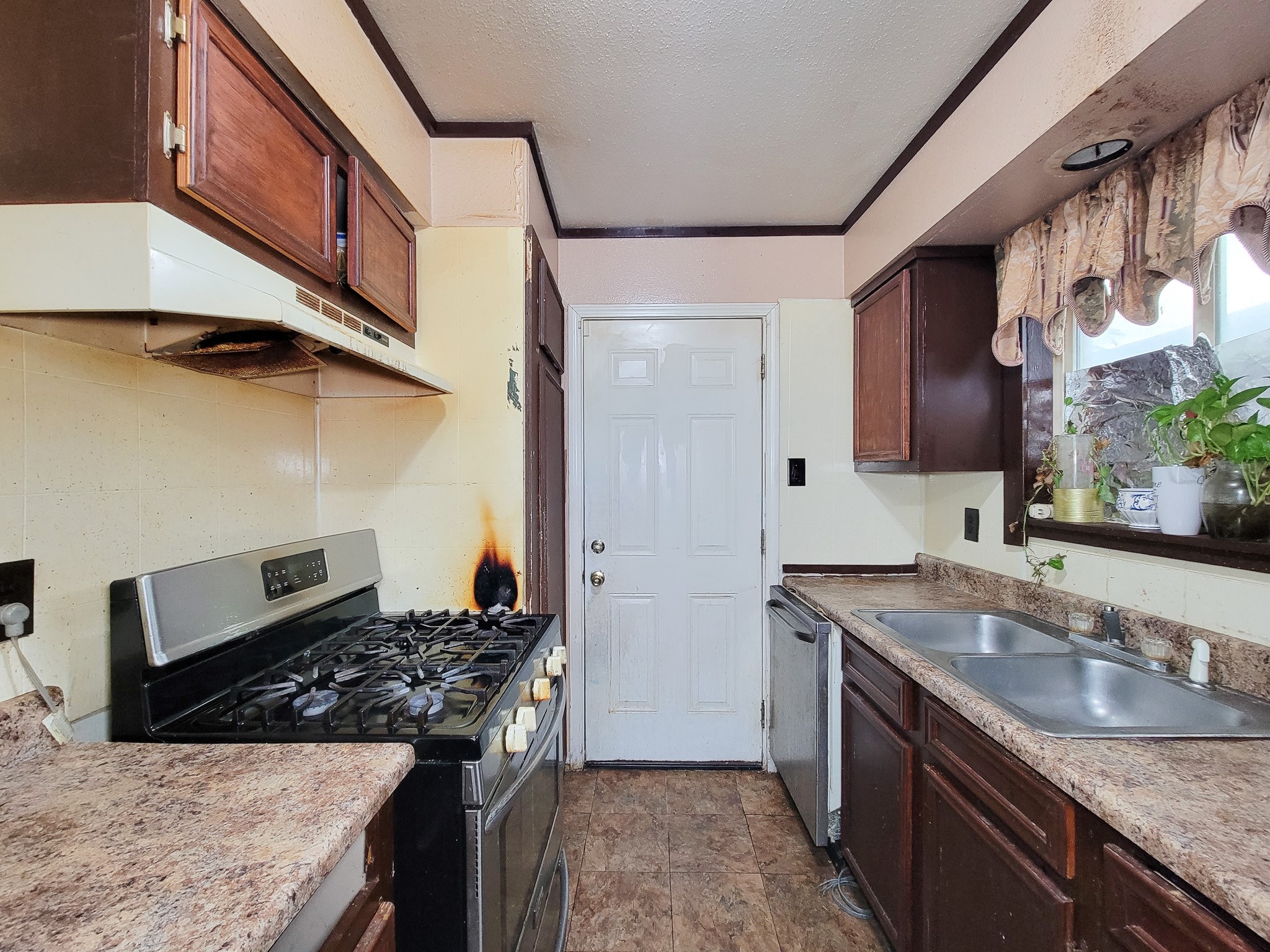 1330 Mosher Lane Houston, TX 77088 - Photo 9 of 16 a kitchen with stainless steel appliances granite countertop a sink stove and cabinets