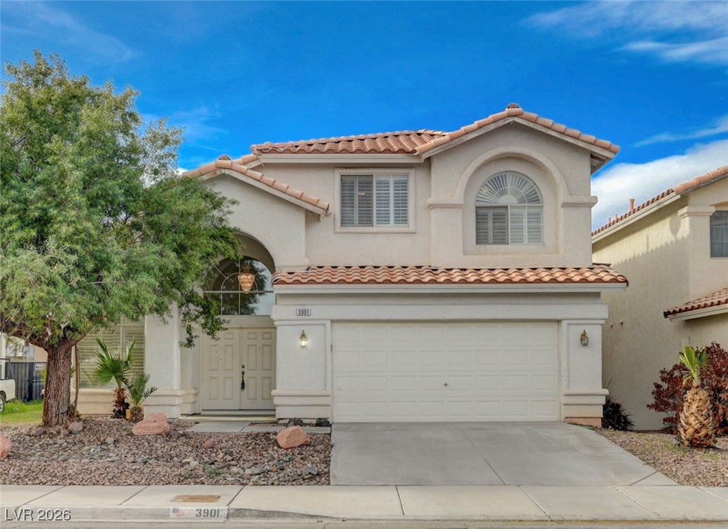 3901 Triora Street Las Vegas, NV 89129 - Photo 1 of 42 Mediterranean / spanish-style home with a tile roof, stucco siding, a garage, and concrete driveway