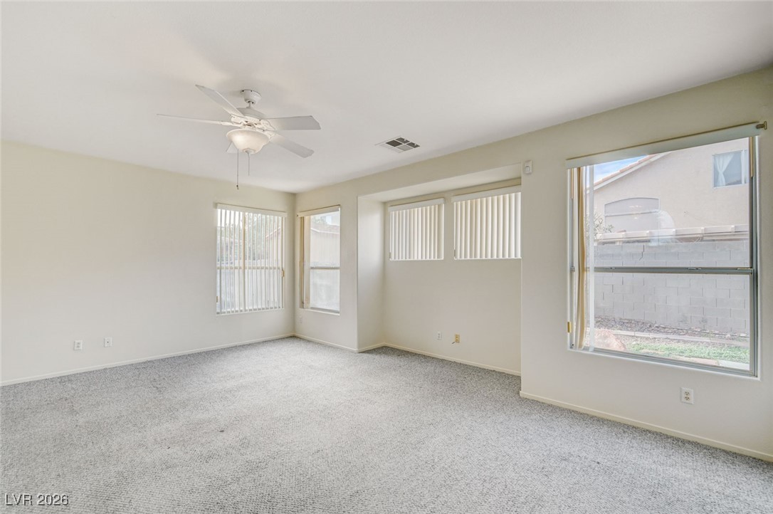 3901 Triora Street Las Vegas, NV 89129 - Photo 11 of 42 Carpeted empty room featuring baseboards and a ceiling fan