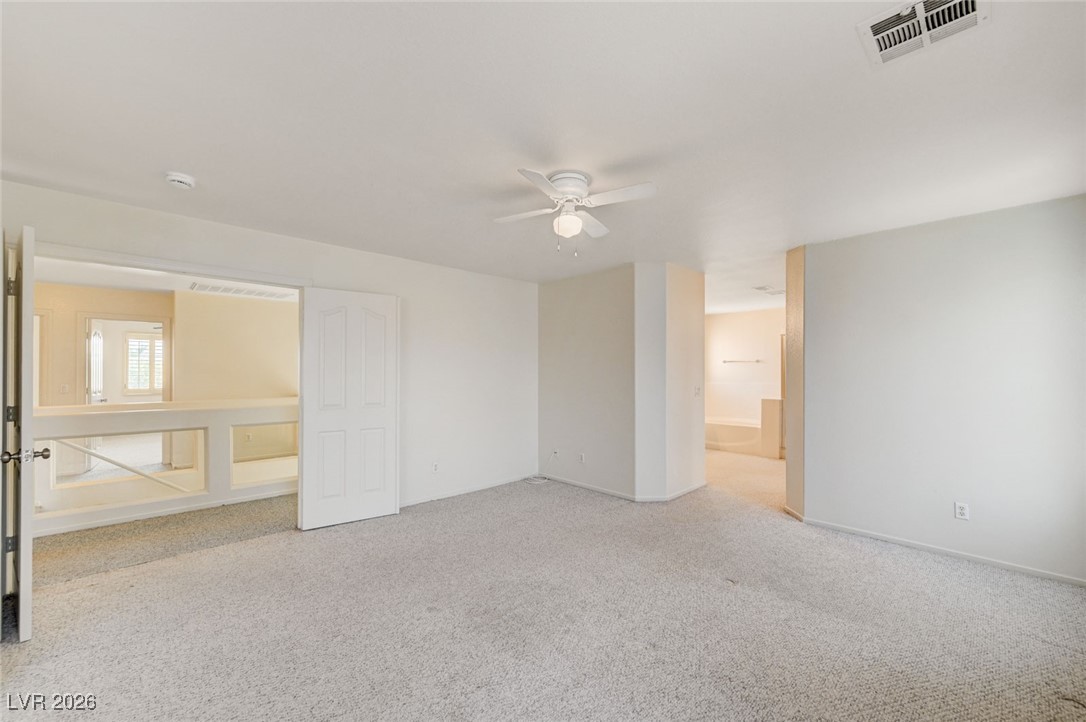 3901 Triora Street Las Vegas, NV 89129 - Photo 19 of 42 Unfurnished bedroom featuring light colored carpet, ceiling fan, and ensuite bathroom