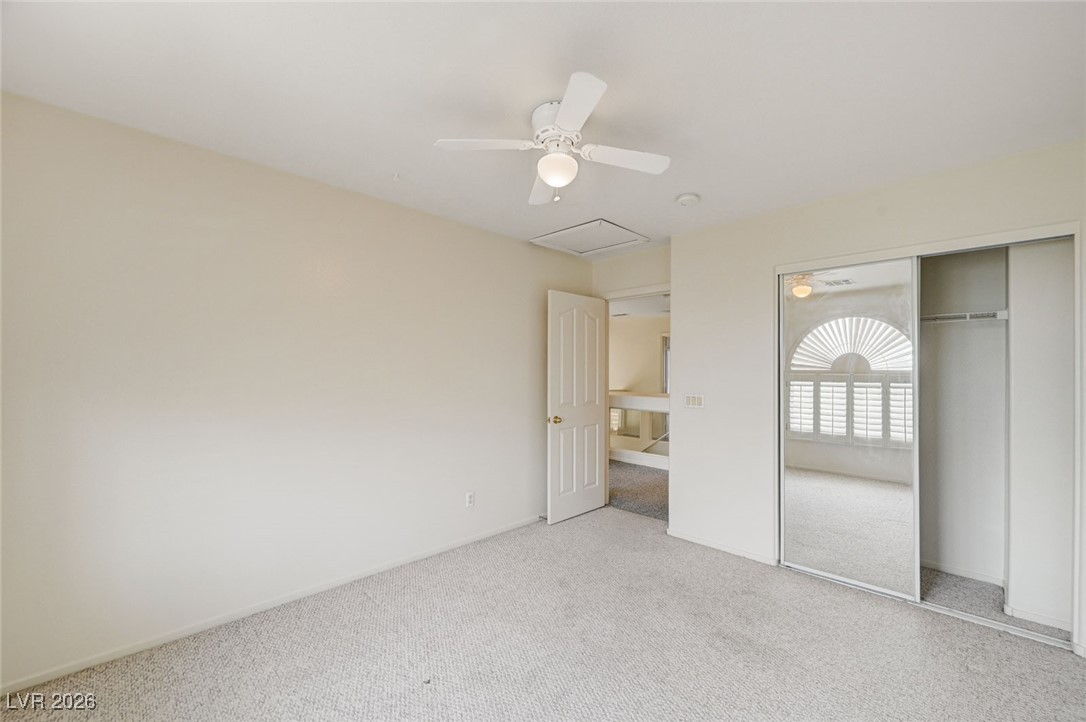 3901 Triora Street Las Vegas, NV 89129 - Photo 31 of 42 Unfurnished bedroom featuring carpet flooring, a ceiling fan, attic access, and a closet