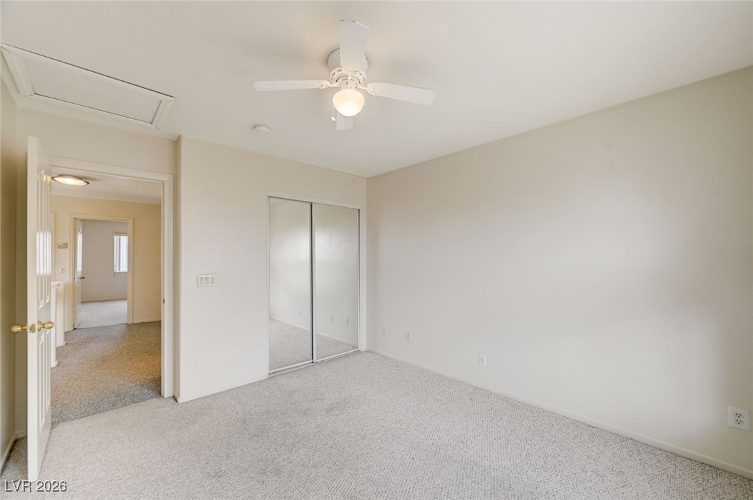3901 Triora Street Las Vegas, NV 89129 - Photo 32 of 42 Unfurnished bedroom featuring carpet, a closet, ceiling fan, and attic access
