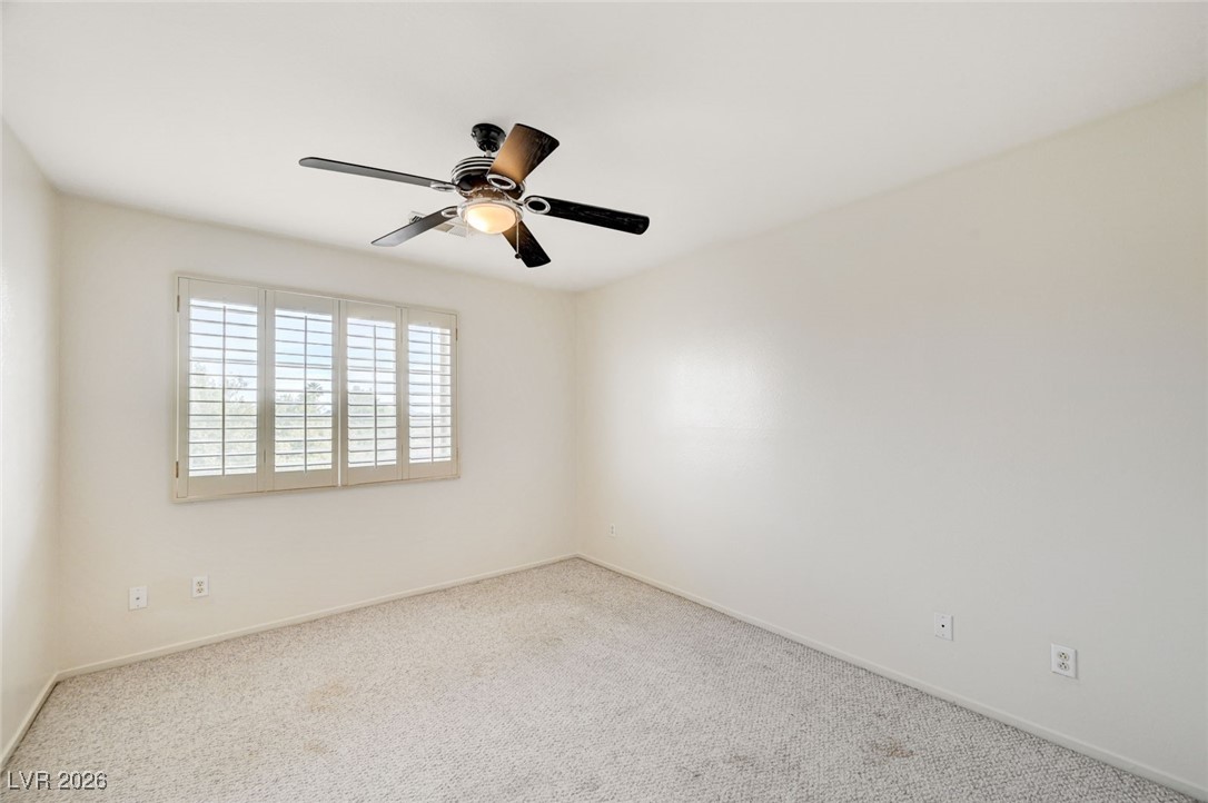 3901 Triora Street Las Vegas, NV 89129 - Photo 33 of 42 Carpeted empty room featuring baseboards and a ceiling fan