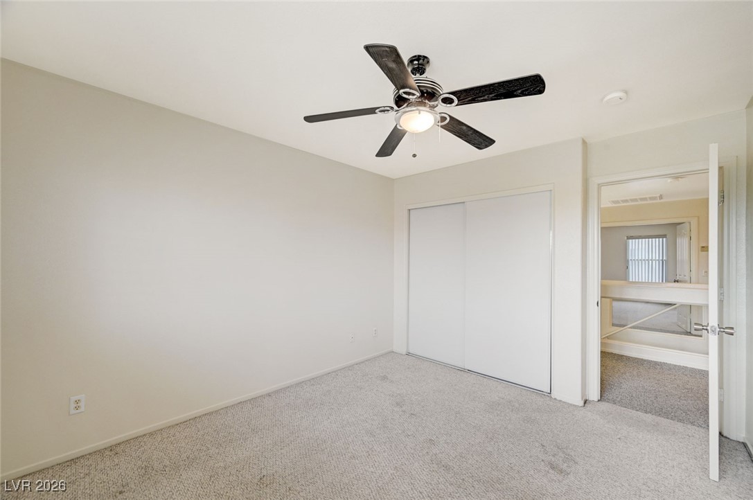 3901 Triora Street Las Vegas, NV 89129 - Photo 35 of 42 Unfurnished bedroom featuring carpet floors, a ceiling fan, and a closet