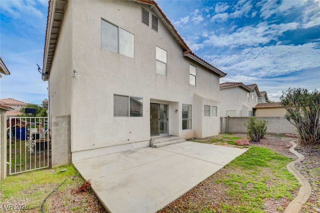 3901 Triora Street Las Vegas, NV 89129 - Photo 38 of 42 Back of property with a patio area, stucco siding, a fenced backyard, and a tile roof