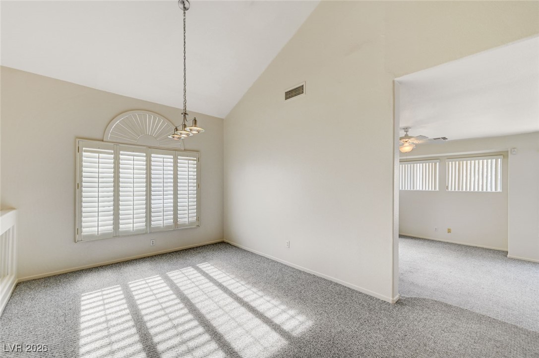 3901 Triora Street Las Vegas, NV 89129 - Photo 7 of 42 Unfurnished dining area featuring carpet floors, high vaulted ceiling, and a ceiling fan