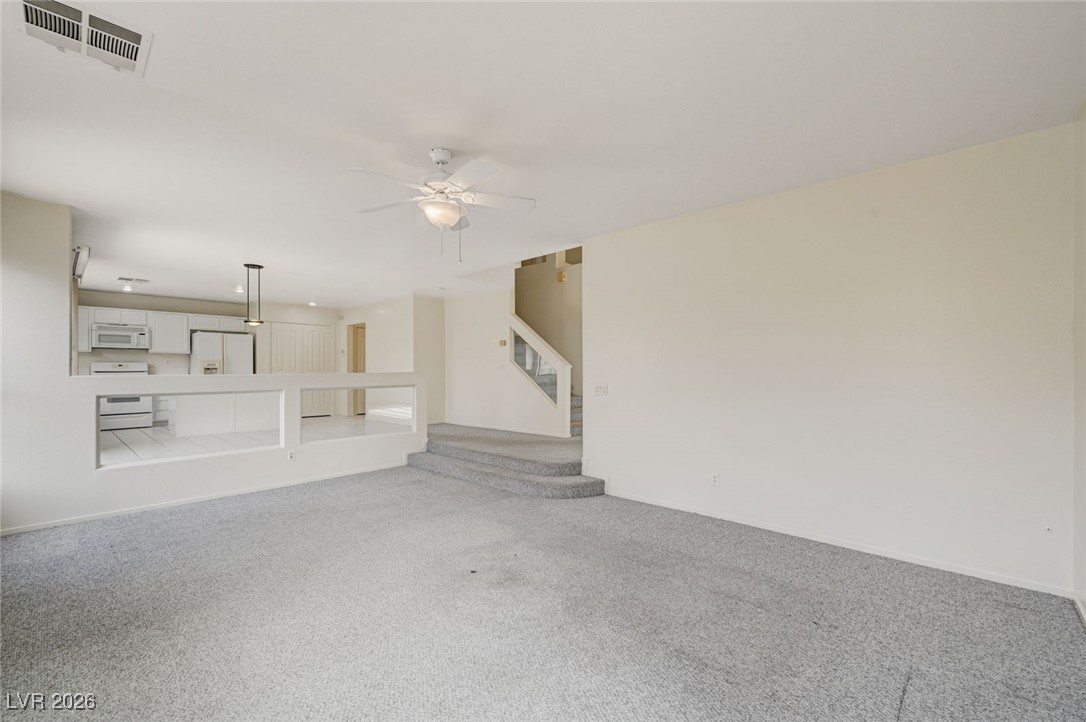 3901 Triora Street Las Vegas, NV 89129 - Photo 9 of 42 Unfurnished living room with carpet and ceiling fan