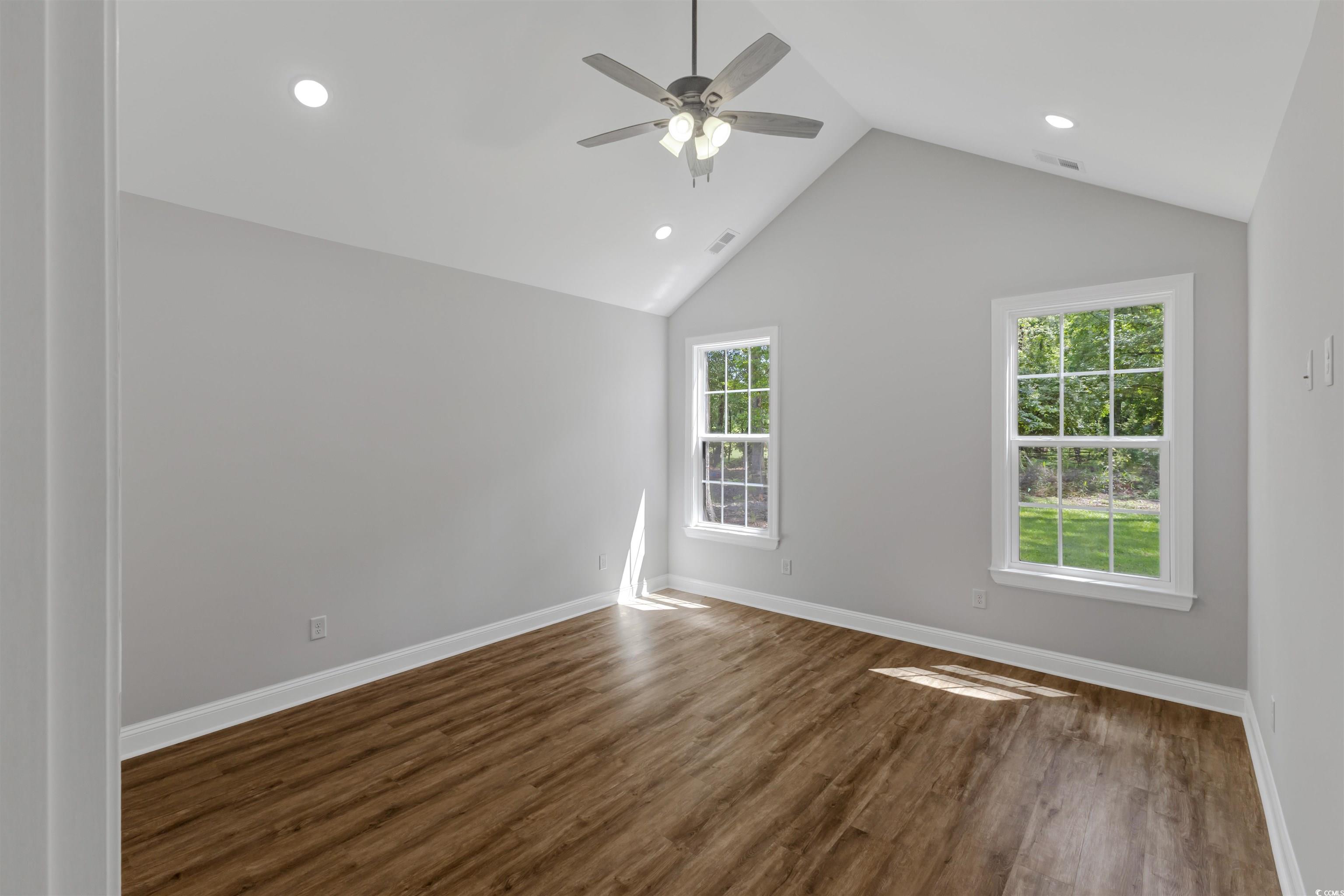4121 Whatuthink Road Myrtle Beach, SC 29588 - Photo 16 of 28 Master Bedroom with a ceiling fan, LVP flooring, recessed lighting, vaulted ceiling, and baseboards