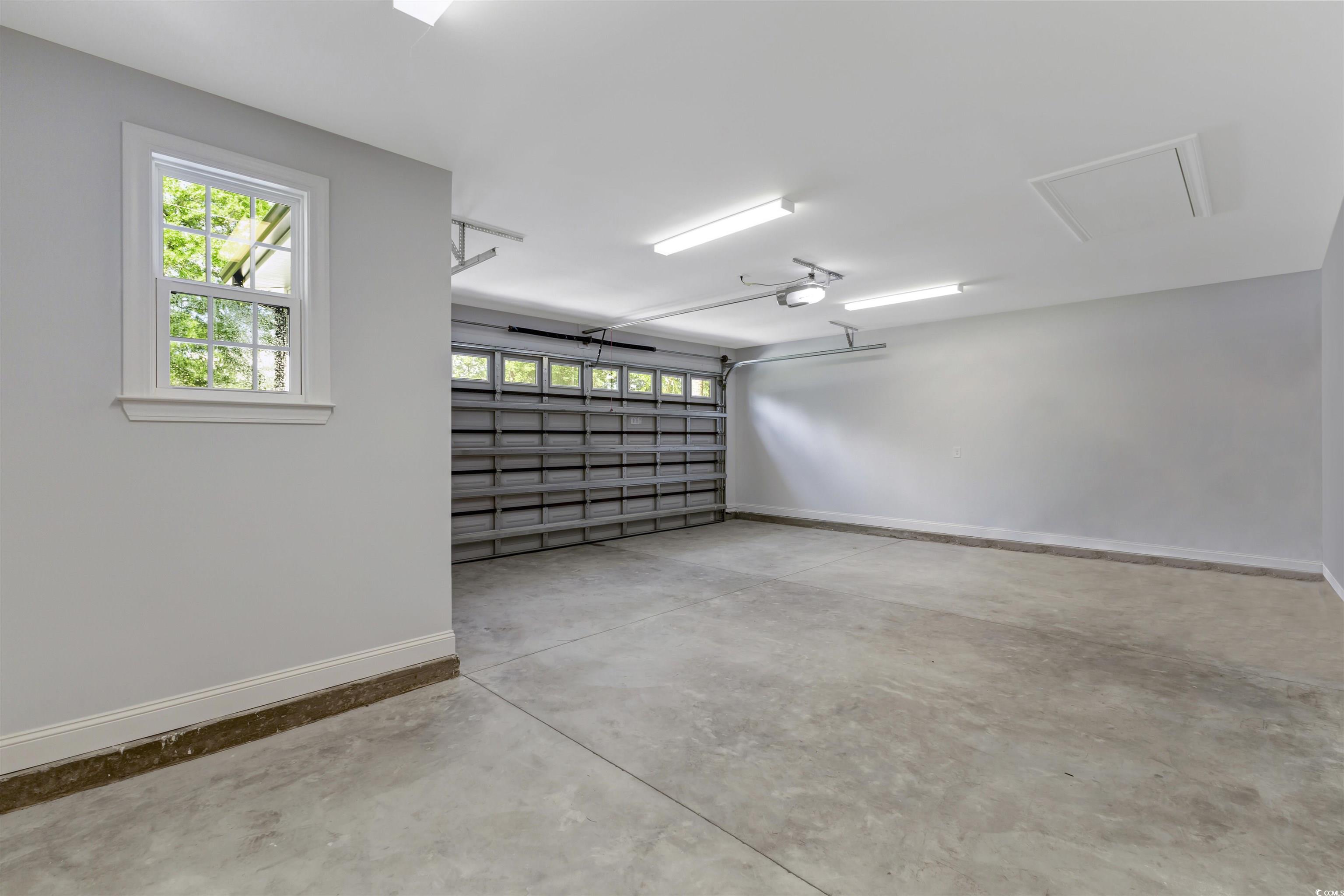 4121 Whatuthink Road Myrtle Beach, SC 29588 - Photo 26 of 28 Garage with baseboards and a garage door opener