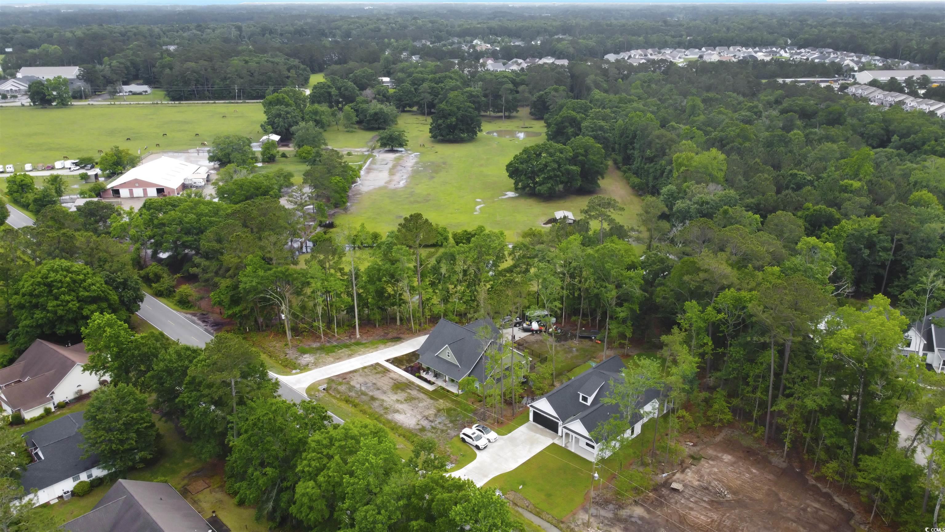 4121 Whatuthink Road Myrtle Beach, SC 29588 - Photo 27 of 28 Aerial perspective of suburban area featuring a forest