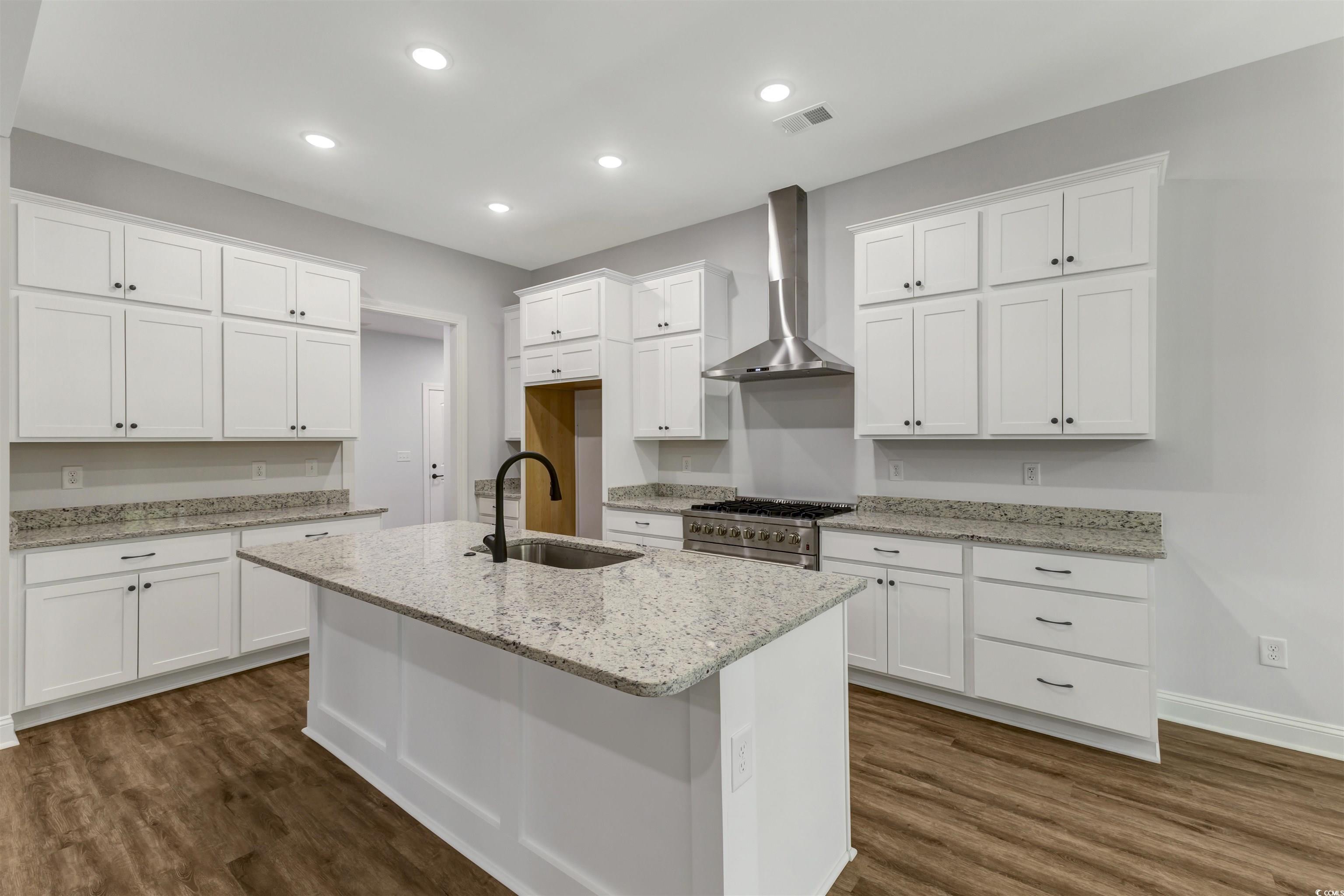 4121 Whatuthink Road Myrtle Beach, SC 29588 - Photo 10 of 28 Kitchen featuring a sink, wall chimney range hood, white cabinets, and recessed lighting