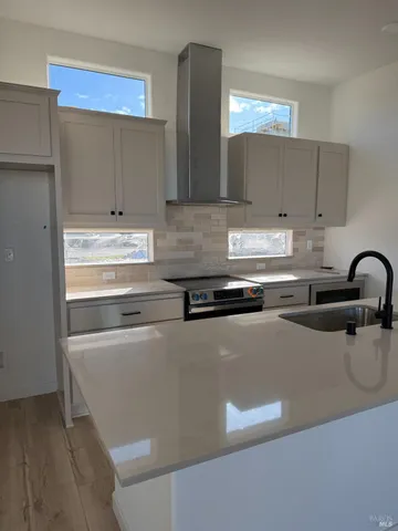 a kitchen with stainless steel appliances granite countertop a sink and a stove