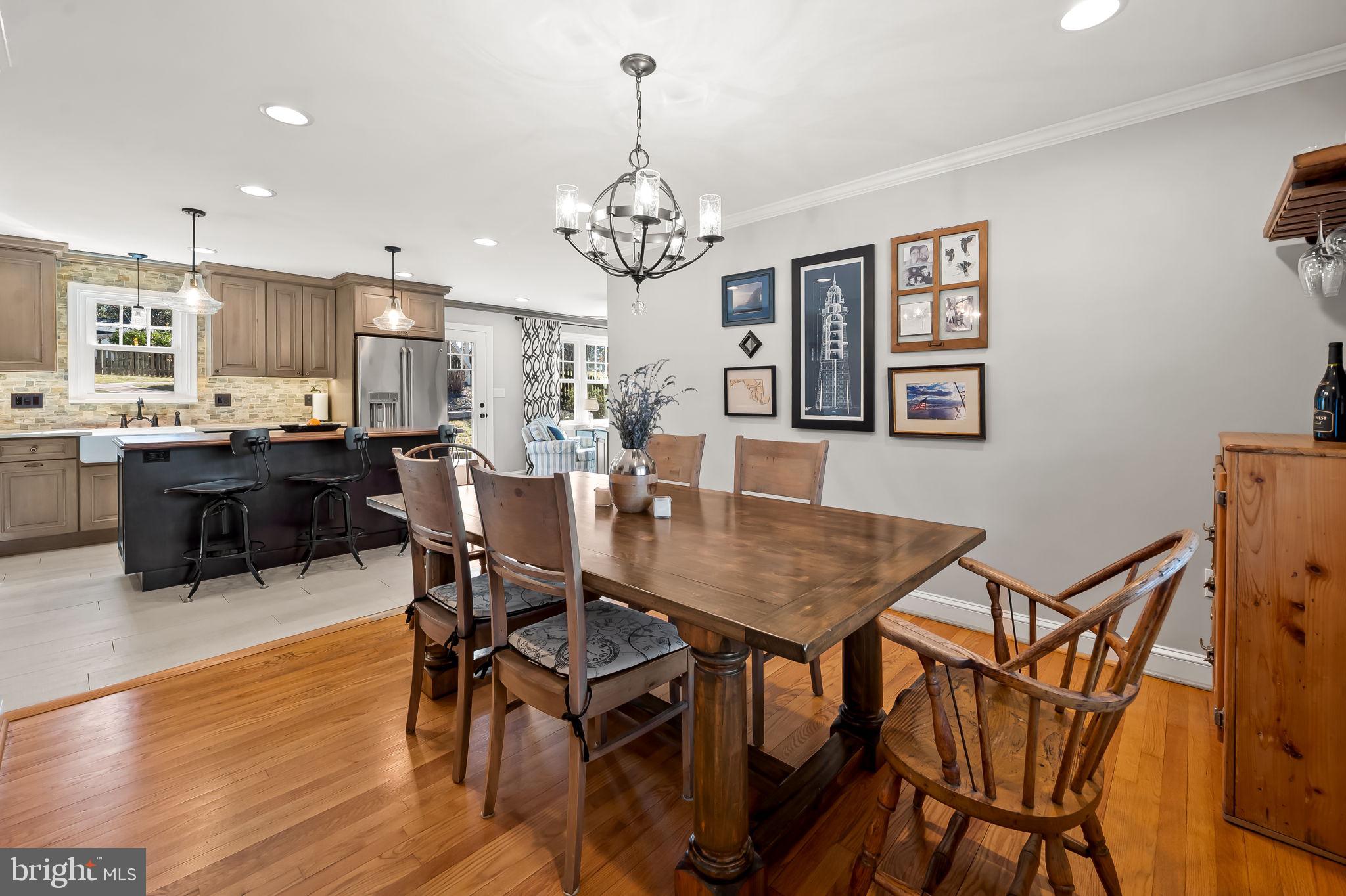 7919 Springway Road Towson, MD 21204 - Photo 11 of 46 a view of a dining room with furniture a chandelier and wooden floor