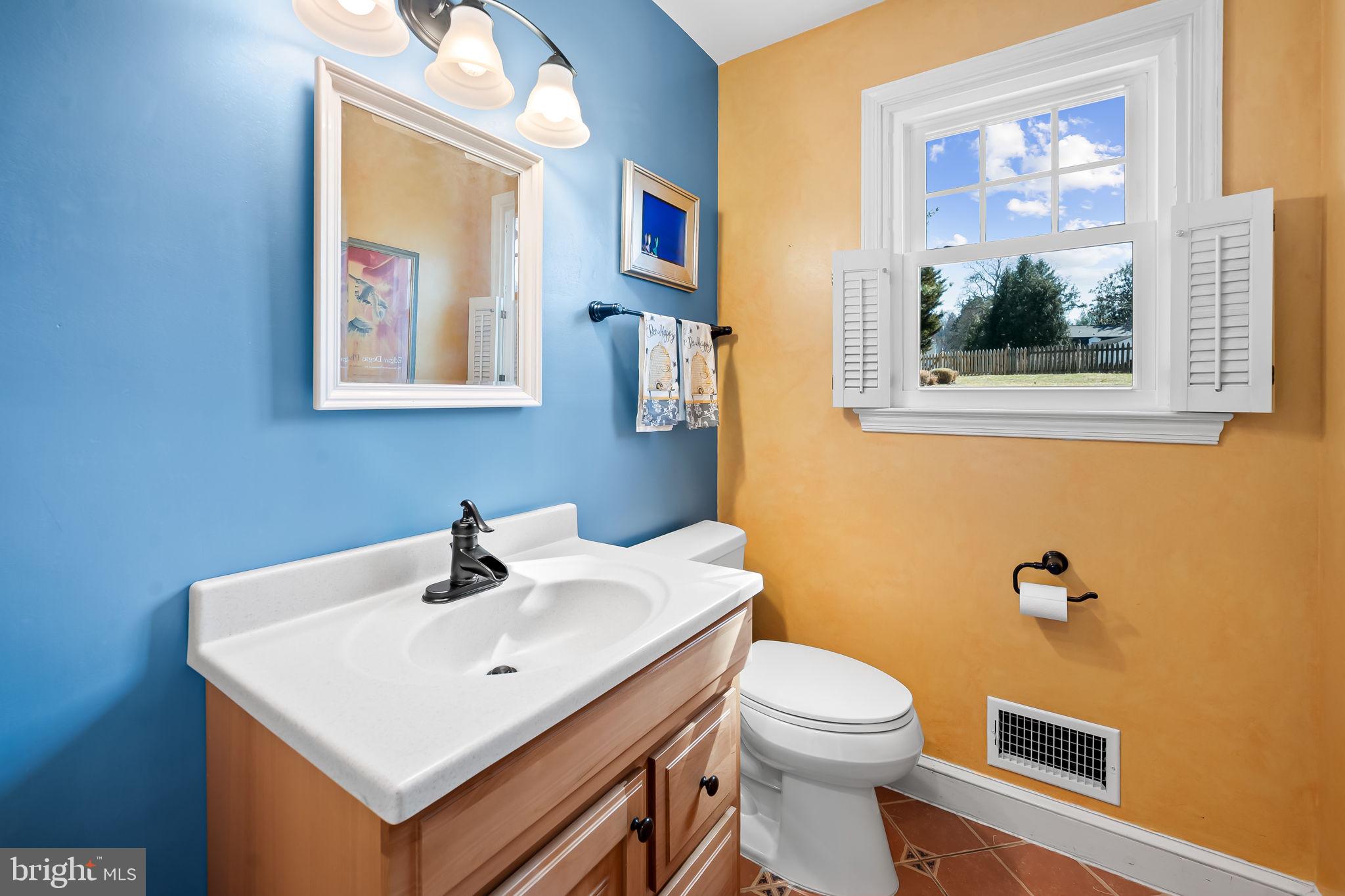 7919 Springway Road Towson, MD 21204 - Photo 18 of 46 a bathroom with a toilet sink and mirror