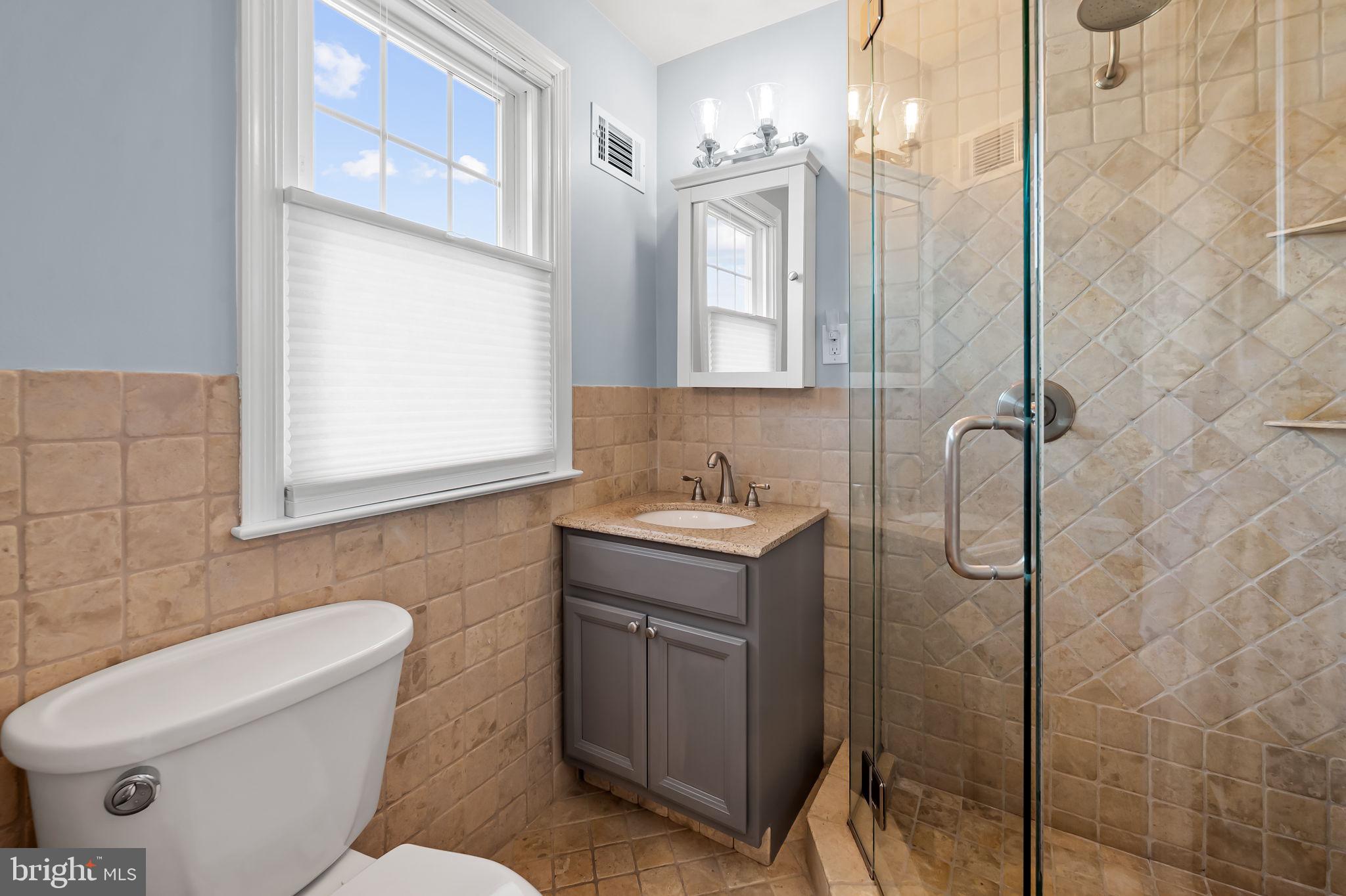 7919 Springway Road Towson, MD 21204 - Photo 23 of 46 a bathroom with a toilet sink and mirror