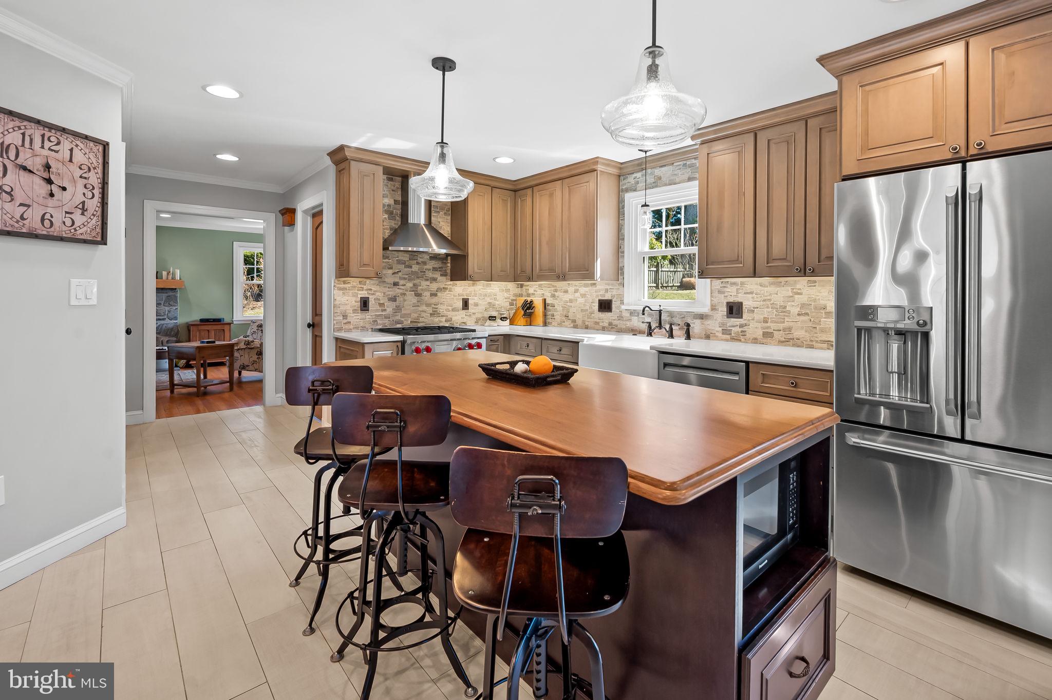 7919 Springway Road Towson, MD 21204 - Photo 6 of 46 a kitchen with stainless steel appliances granite countertop a sink a stove a refrigerator and island
