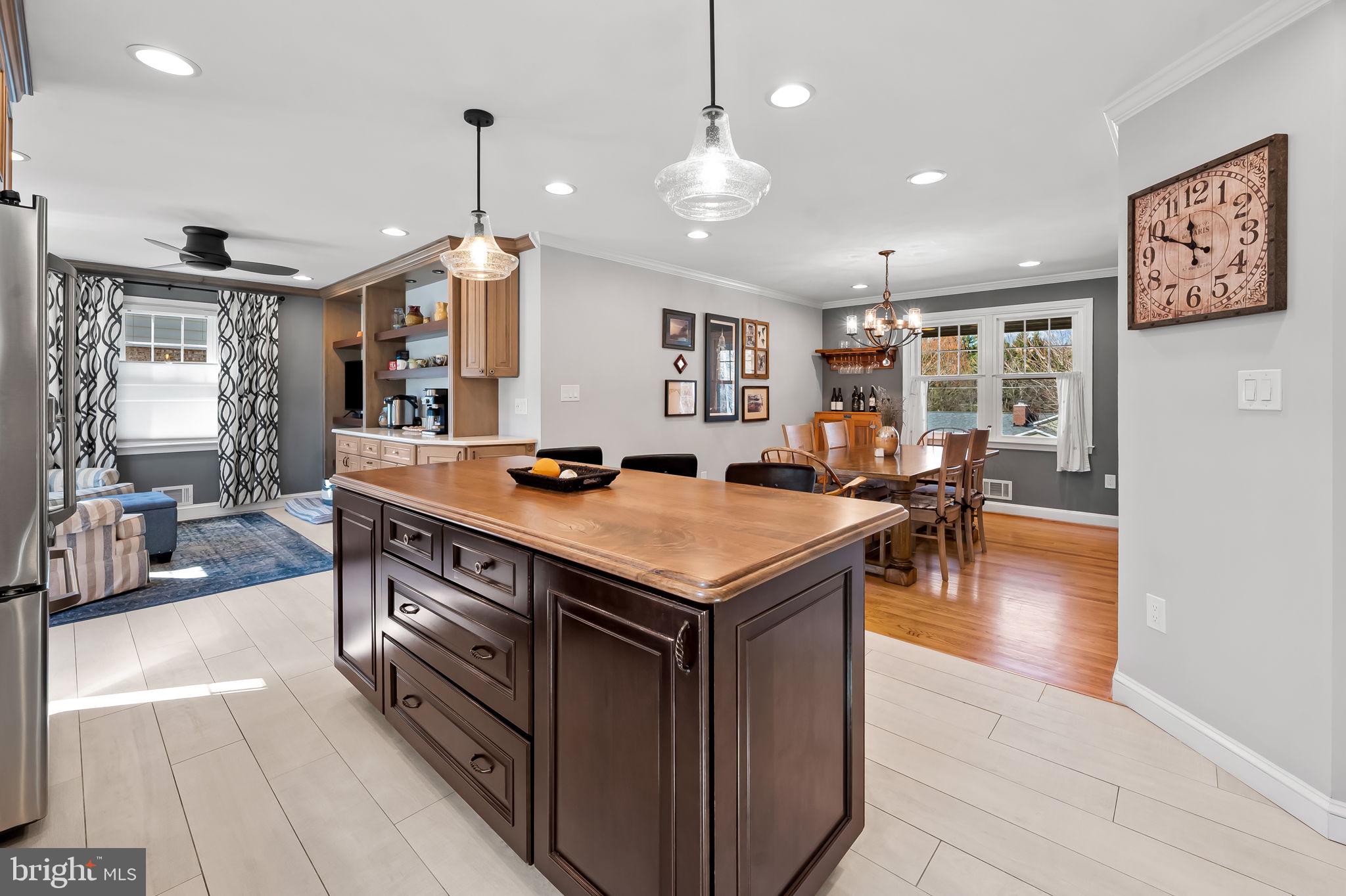 7919 Springway Road Towson, MD 21204 - Photo 8 of 46 a kitchen with a stove a counter space dining table and chairs