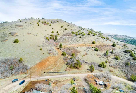a view of a dry yard with mountains in the background