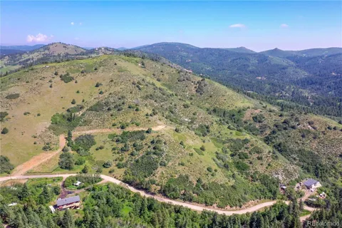 a view of a mountain with a lush green hillside