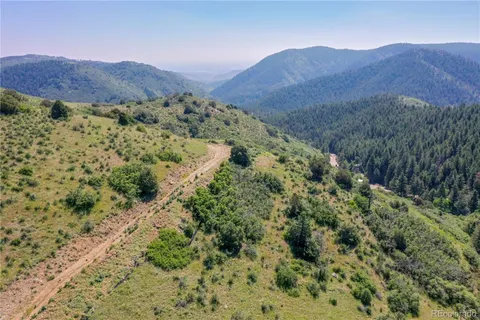 a view of a lush green hillside and a building