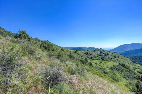 a view of a mountain range with trees in the background